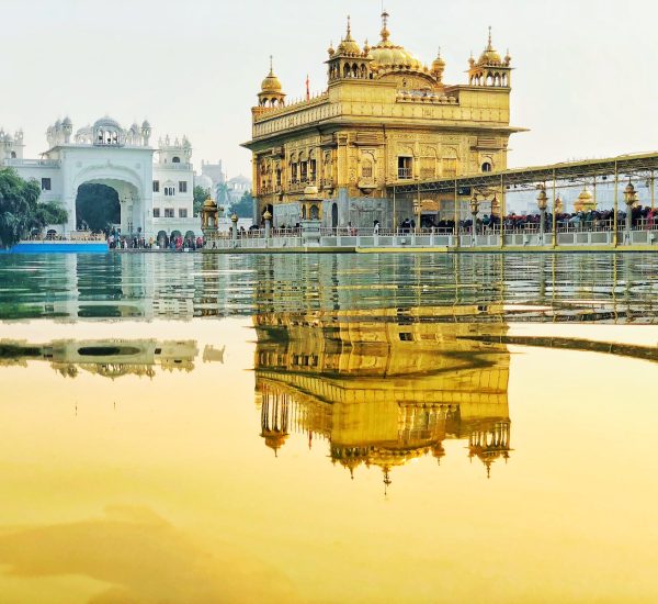 yellow temple near body of water