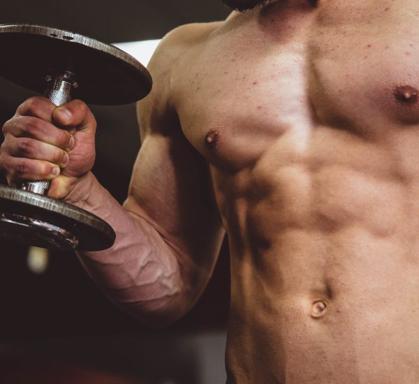 man holding black dumbbell